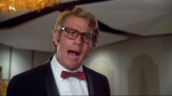 Movie still from “What's Up, Doc?” (1972), directed by Peter Bogdanovich – A person wearing glasses and a bow tie; Close Up shot, Low angle