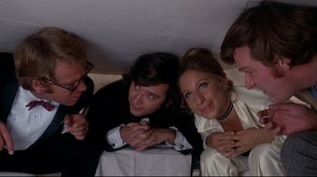 Movie still from “What's Up, Doc?” (1972), directed by Peter Bogdanovich – A group of people that are sitting down together; Medium shot, Overhead angle