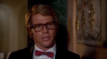 Movie still from “What's Up, Doc?” (1972), directed by Peter Bogdanovich – A person wearing glasses and a bow tie; Close Up shot, Low angle