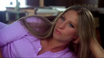 Movie still from “What's Up, Doc?” (1972), directed by Peter Bogdanovich – A woman in a purple shirt is laying down; Close Up shot, High angle
