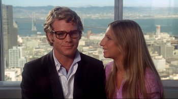 Movie still from “What's Up, Doc?” (1972), directed by Peter Bogdanovich – A man and a woman standing next to each other in front of a city skyline; Close Up shot, Over the shoulder angle