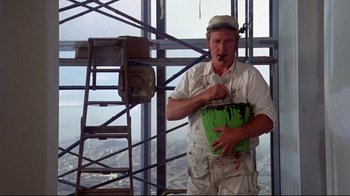 Movie still from “What's Up, Doc?” (1972), directed by Peter Bogdanovich – A man holding a paint bucket on top of a building; Medium shot, Low angle