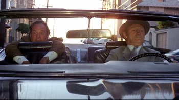 Movie still from “What's Up, Doc?” (1972), directed by Peter Bogdanovich – Two men in suits and hats driving in a car; Medium shot, Low angle