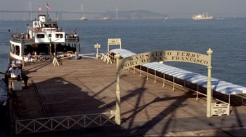 Movie still from “What's Up, Doc?” (1972), directed by Peter Bogdanovich – A pier with a boat in the water and a bridge in the background; Extreme Wide shot, High angle