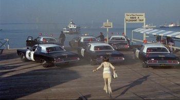 Movie still from “What's Up, Doc?” (1972), directed by Peter Bogdanovich – A group of police cars driving down a street; Extreme Wide shot, High angle