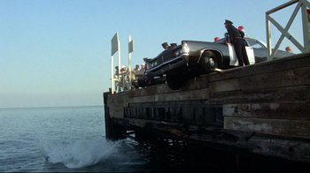 Movie still from “What's Up, Doc?” (1972), directed by Peter Bogdanovich – A car that is sitting in the water on top of a dock; Extreme Wide shot, High angle