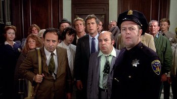Movie still from “What's Up, Doc?” (1972), directed by Peter Bogdanovich – A group of men in suits and ties standing next to each other in a room; Medium shot, High angle