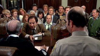 Movie still from “What's Up, Doc?” (1972), directed by Peter Bogdanovich – A group of people sitting around a table; Medium shot, High angle