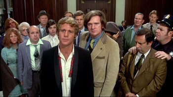 Movie still from “What's Up, Doc?” (1972), directed by Peter Bogdanovich – A group of people standing in front of each other; Medium shot, Low angle