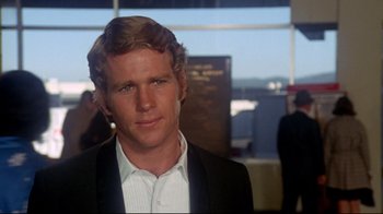 Movie still from “What's Up, Doc?” (1972), directed by Peter Bogdanovich – A person wearing a suit and tie; Close Up shot, Over the shoulder angle