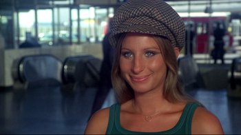 Movie still from “What's Up, Doc?” (1972), directed by Peter Bogdanovich – A woman wearing a hat and smiling for the camera; Close Up shot, High angle