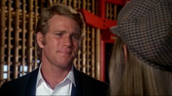 Movie still from “What's Up, Doc?” (1972), directed by Peter Bogdanovich – A man wearing a hat and a suit; Close Up shot, Over the shoulder angle