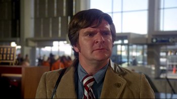 Movie still from “What's Up, Doc?” (1972), directed by Peter Bogdanovich – A man in a brown jacket and a red tie; Close Up shot, Low angle