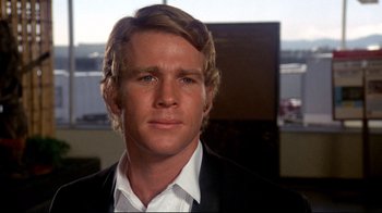 Movie still from “What's Up, Doc?” (1972), directed by Peter Bogdanovich – A person wearing a suit and tie; Close Up shot, Over the shoulder angle