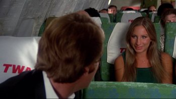 Movie still from “What's Up, Doc?” (1972), directed by Peter Bogdanovich – A man and a woman sitting on a train; Medium shot, High angle