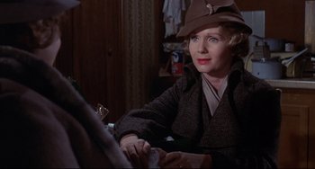 Movie still from “What's the Matter with Helen?” (1971), directed by Curtis Harrington – An older woman wearing a brown hat and a brown jacket; Close Up shot, Over the shoulder angle