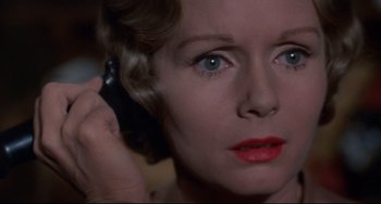 Movie still from “What's the Matter with Helen?” (1971), directed by Curtis Harrington – A person talking on a cell phone; Close Up shot, High angle