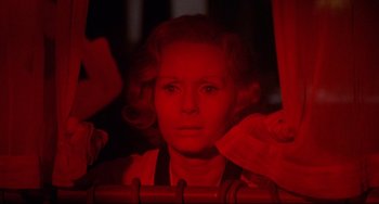 Movie still from “What's the Matter with Helen?” (1971), directed by Curtis Harrington – A woman is looking out of a car window at night; Close Up shot, Low angle