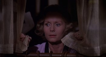 Movie still from “What's the Matter with Helen?” (1971), directed by Curtis Harrington – A person looking at something in a mirror; Close Up shot, Low angle