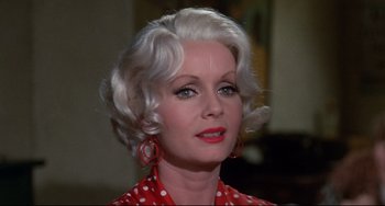 Movie still from “What's the Matter with Helen?” (1971), directed by Curtis Harrington – An older woman with white hair wearing a red polka dot shirt; Close Up shot, Low angle