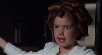 Movie still from “What's the Matter with Helen?” (1971), directed by Curtis Harrington – A little girl that is sitting in a chair; Close Up shot, High angle