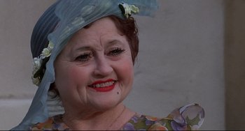 Movie still from “What's the Matter with Helen?” (1971), directed by Curtis Harrington – An older woman wearing a blue hat with flowers on it; Close Up shot, Low angle