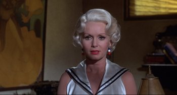 Movie still from “What's the Matter with Helen?” (1971), directed by Curtis Harrington – An older woman with white hair and a sailor suit; Close Up shot, Low angle