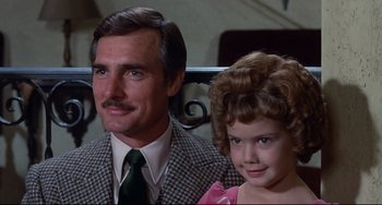 Movie still from “What's the Matter with Helen?” (1971), directed by Curtis Harrington – A man and a little girl sitting next to each other; Close Up shot, Low angle