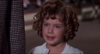 Movie still from “What's the Matter with Helen?” (1971), directed by Curtis Harrington – A little girl that is smiling for the camera; Close Up shot, High angle