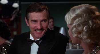 Movie still from “What's the Matter with Helen?” (1971), directed by Curtis Harrington – A man wearing a tuxedo and a bow tie; Close Up shot, Over the shoulder angle