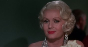 Movie still from “What's the Matter with Helen?” (1971), directed by Curtis Harrington – A person wearing a dress; Close Up shot, Over the shoulder angle