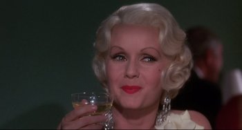 Movie still from “What's the Matter with Helen?” (1971), directed by Curtis Harrington – An older woman holding a glass of wine in her hand; Close Up shot, Over the shoulder angle