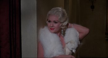 Movie still from “What's the Matter with Helen?” (1971), directed by Curtis Harrington – A woman with blonde hair wearing a white fur stole; Close Up shot, High angle