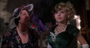 Movie still from “What's the Matter with Helen?” (1971), directed by Curtis Harrington – Two women dressed up and one is wearing a green dress; Close Up shot, Over the shoulder angle