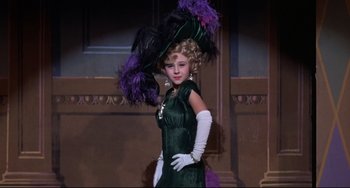 Movie still from “What's the Matter with Helen?” (1971), directed by Curtis Harrington – A young girl in a green dress and a purple hat; Medium shot, Low angle