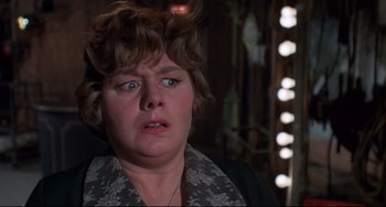 Movie still from “What's the Matter with Helen?” (1971), directed by Curtis Harrington – An older woman with blue eyes is looking at the camera; Close Up shot, Over the shoulder angle
