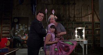 Movie still from “What's the Matter with Helen?” (1971), directed by Curtis Harrington – A man and a woman and a little girl in costume; Medium shot, Over the shoulder angle