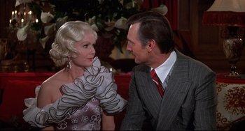Movie still from “What's the Matter with Helen?” (1971), directed by Curtis Harrington – An older man and a younger woman in formal wear; Close Up shot, Over the shoulder angle