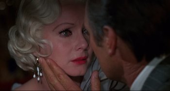 Movie still from “What's the Matter with Helen?” (1971), directed by Curtis Harrington – An older man touching a woman's face with her hand; Close Up shot, Over the shoulder angle