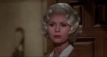 Movie still from “What's the Matter with Helen?” (1971), directed by Curtis Harrington – An older woman with white hair and red lipstick; Close Up shot, Over the shoulder angle