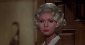 Movie still from “What's the Matter with Helen?” (1971), directed by Curtis Harrington – An older woman with white hair and red lipstick; Close Up shot, Over the shoulder angle
