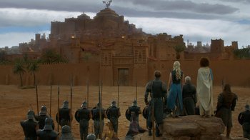 Movie still from “Game of Thrones” (2011), created by D.B. Weiss – A group of people standing in front of a building; Extreme Wide shot, Low angle