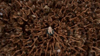 Movie still from “Game of Thrones” (2011), created by D.B. Weiss – A crowd of people reaching up to reach a woman; Extreme Wide shot, Overhead angle