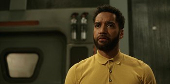 Movie still from “Another Life” (2019), created by Aaron Martin – A man with a beard looking up; Close Up shot, Low angle