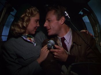 Movie still from “When Worlds Collide” (1951), directed by Rudolph Maté – A man and a woman are sitting in the back of a car; Medium shot, Low angle