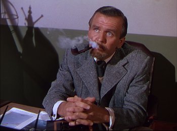 Movie still from “When Worlds Collide” (1951), directed by Rudolph Maté – A man smoking a pipe while sitting at a table; Medium shot, Low angle