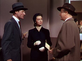 Movie still from “When Worlds Collide” (1951), directed by Rudolph Maté – A man and two women standing next to each other; Medium shot, Over the shoulder angle