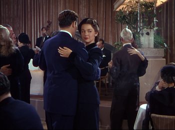 Movie still from “When Worlds Collide” (1951), directed by Rudolph Maté – A man and a woman are dancing in front of other people; Medium shot, Low angle