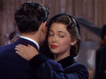 Movie still from “When Worlds Collide” (1951), directed by Rudolph Maté – A man and a woman embracing each other in front of a wooden wall; Close Up shot, Over the shoulder angle