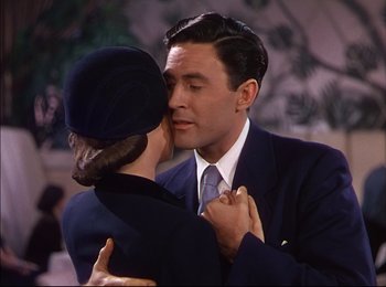 Movie still from “When Worlds Collide” (1951), directed by Rudolph Maté – A man and a woman are kissing in a room; Close Up shot, High angle